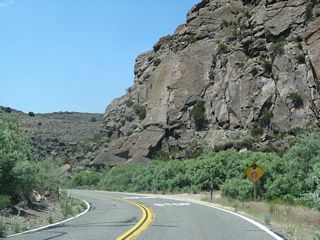 A "stop ahead" sign is posted prior to the U.S. 395 intersection.