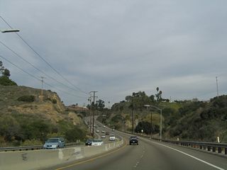 Through the dedicated open space of Tecolote Canyon, Balboa Avenue assumes the appearance of an expressway. The former state route was repaved in 1999, prior to the relinquishment of Balboa Avenue to the city. Most streets maintained by the City of San Diego do not use raised pavement markers (Botts Dots) to delineate lanes. The use of Botts Dots through Tecolote Canyon clearly shows that the road was built to Caltrans rather than City standards.