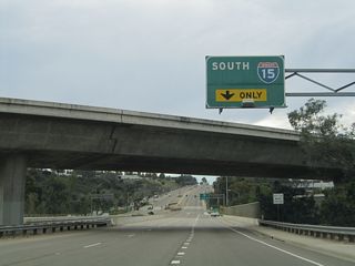 Balboa Avenue passes under the flyover ramp that connects Interstate 15 with old SR 274 west. This ramp was built partially with funds from General Dynamics, a large aerospace defense industry contractor that had large labor pools in the 1980s. A large General Dynamics facility used to be located in Kearny Mesa, and commuters would use the connection to get to work. Today, the General Dynamics facility is located where the San Diego Spectrum is located.