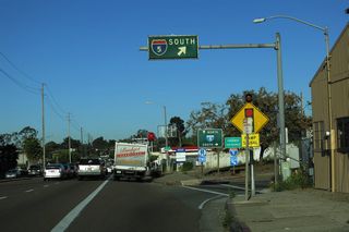 Westbound Garnet (Balboa) Avenue reaches the loop for Interstate 5 south after passing under the freeway and by businesses.