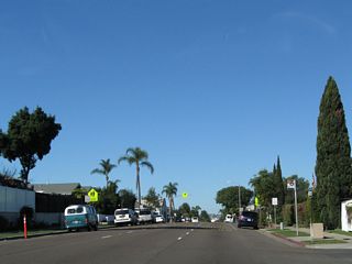 After the Orange Avenue intersection, three lanes carry traffic from the Coronado Business District toward the main gate entrance to the base.