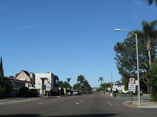 The next intersection along California 282 (Third Street) west is a six-way intersection with north-south H Street and northwest-southeast Palm Avenue. On the north side of the street is Palm Park, which is bounded by Palm Avenue, Third Street, and I Avenue.