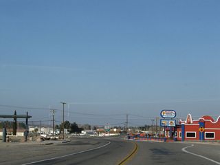 The U.S. highways used to divide at the intersection with First Avenue, which is the next stop sign. Old U.S. 91 shifts southwest along 1st Avenue into Barstow while former U.S. 466 and Old Highway 58 turn proceed west to Irwin Road and Lenwood Road linking with SR 58.