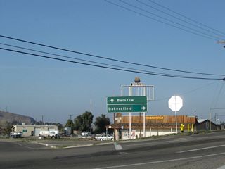 The sign referencing Barstow (via Historic U.S. 91 south) and Bakersfield (via Old Highway 58 west) at First Avenue and Old Highway 58 was removed by 2023. The green overlay on the sign covered an SR 58 shield.