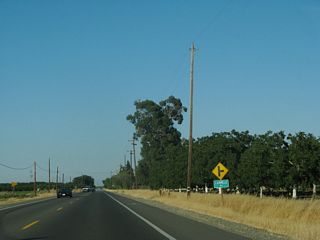Carmelo Way (Road 91E) spurs south from County Route E6 (Russell Boulevard) to agricultural areas.