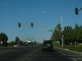 John Jones Road north from Covell Boulevard (CR E-6) forms the west side frontage road paralleling the freeway along SR 113.