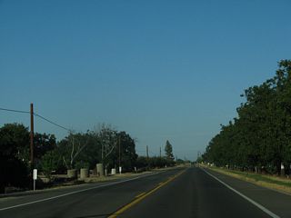 Russell Boulevard continues by a variety of orchards, ranches and farms. This stretch of CR E-6 appears to match or exceed the standards for a typical, rural, two-lane state route.