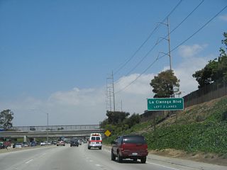 Once on the off-ramp to La Cienega Boulevard and Manchester Boulevard, stay left to follow La Cienega Boulevard. This interchange was configured as a freeway-to-freeway interchange, even though the freeway to La Cienega Boulevard was never built.