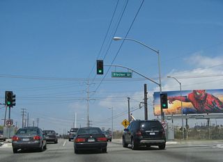 Northbound La Cienega Boulevard meets Stocker Street at this traffic signal. The freeway resumes ahead.