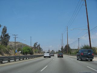 La Cienega Boulevard continues through the industrial Baldwin Hills area. Look for oil derricks and other oil-related plants nearby.