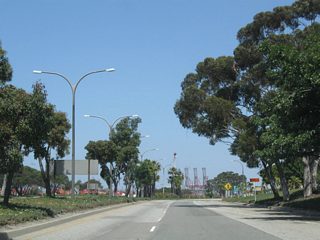 Tall trees and green medians give Harbor Scenic Drive a parkway like feel. Although some of the signs look like Caltrans standard, the highway is maintained by the Port of Long Beach.