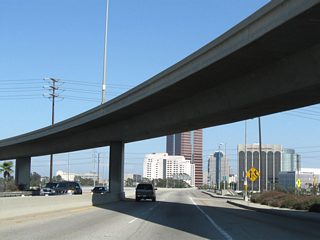 The transition ramp from the Gerald Desmond Bridge to the Long Beach Freeway flies over Ocean Boulevard beyond the Pico Street off-ramp