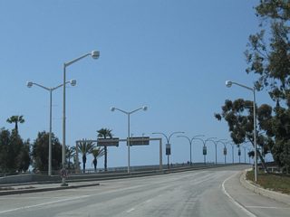 Traffic from Shoreline Drive merges onto southbound Queens Way as the freeway proceeds south over the mouth of the Los Angeles River. The Queensway Bay Bridge opened to traffic in 1969.