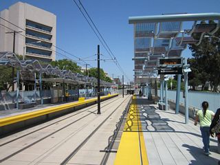 Located in the median of Exposition Boulevard, this at-grade station for the Expo Line is located adjacent to the entrance to the rose garden at Exposition Park and the southern edge of the University of Southern California.