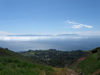 This view looks down from a trail connecting with the south end of Crenshaw Boulevard on Rancho Palos Verdes south toward the Pacific Ocean and Santa Catalina Island.