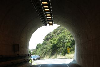 A traffic signal controls the flow of traffic into the tunnel, since only one direction may proceed at a time