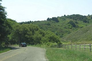 Muir Woods Road leaves the vicinity of the national monument and proceeds west toward Muir Beach and SR 1 (Shoreline Highway)