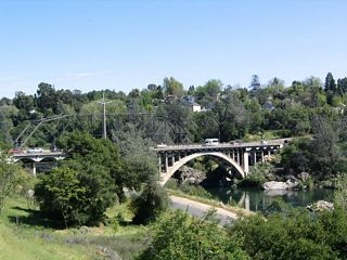 View of the Rainbow Bridge over the American River in Folsom as seen from the Cliff House. This is an early generation concrete arch bridge built in 1917.