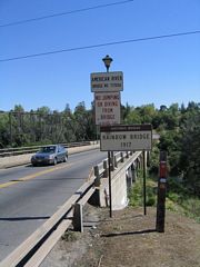 Views of the Rainbow Bridge over the American River as seen along southbound. The bridge was constructed in 1917 and is situated next to an even older truss bridge that today serves as a pedestrian and bicycle bridge. These bridges are located just north of downtown Folsom.