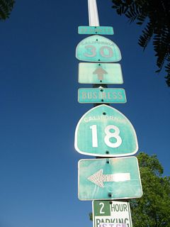 Old, faded shields for the business routes posted just prior to the Sierra Way intersection.