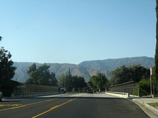 Sierra Way crosses over the freeway along SR 210 without direct access.