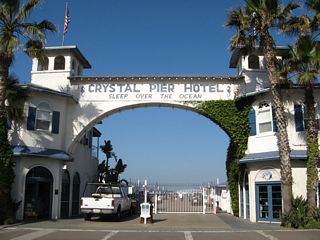 The Crystal Pier Hotel is located at the western end of Garnet Avenue in Pacific Beach. Its arch gracefully extends over the entrance to the pier, which is partially privately owned and partially owned by the city of San Diego.