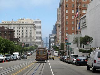 Continuing east, a street car plies along California Street near the Taylor Street.
