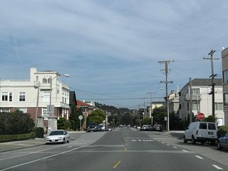 This view shows El Camino del Mar traveling east through Sea Cliff en route to the Presidio. The next stop sign intersection is with 27th Avenue.