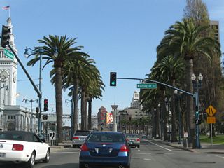 Southbound Embarcadero meets Washington Street at this signalized intersection. This area was dominated by the old Embarcadero Freeway (California 480) before it was demolished in the early 1990s; the Ferry Building was partially hidden by the double-decker freeway.