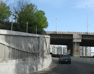 The on-ramp to Interstate 80 east was reconstructed as part of the James Lick Skyway construction. Note the decorative features on the retaining wall of this ramp, which shows the top of one of the suspension towers.