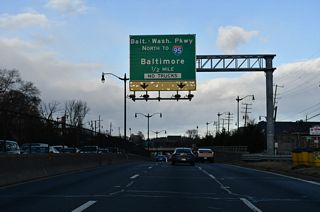 Passing under the Eastern Avenue overpass, D.C. 295 transitions into MD 201 ahead of the exchange joining the northbound beginning of Baltimore Washington Parkway with U.S. 50. All trucks must depart MD 201 (Kenilworth Avenue Freeway) for U.S. 50.