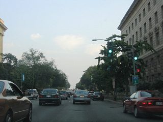 14th Street SW southbound at one of the entrances to the Department of Commerce. An Interstate 495 trailblazer directs motorists southward as 14th Street SW becomes part of U.S. 1.