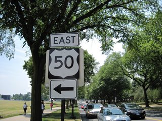 Constitution Avenue doubles as U.S. 50 west to the Theodore Roosevelt Bridge (I-66) and east to 6th Street NW alongside the National Mall. This shield, replaced by 2014, directs 17th Street SW motorists onto U.S. 50 east between The Ellipse and the Washington Monument.