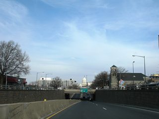 South Capitol Street dives below M Street; frontage streets travel alongside the four lane boulevard above to provide access. M Street joins the Washington Navy Yard with Maine Avenue.