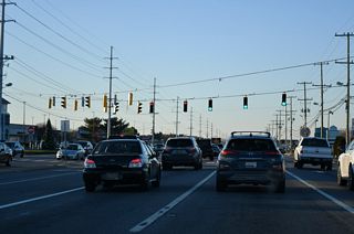 SR 1 (Coastal Highway) continues along a heavily commercialized stretch to the signal with Midway Outlet Drive.