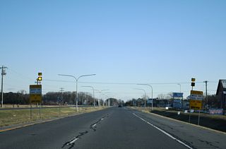 Cave Neck Road (Rd 88) ties into SR 1 (Coastal Highway) near the Payner's Mill development. Cave Neck Road heads west by an array of suburban development off Red Mill Pond to Milton.