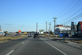 SR 1 southbound at Five Points. The name Five Points was derived from the five-way intersection created by the confluence of Coastal Highway, then SR 18 (U.S. 9), Plantation Road and Beaver Dam Road. Modifications over the years to the junction moved Plantation Road (SR 1D) and Beaver Dam Road (SR 23) away from SR 1, leaving a conventional, but busy intersection.