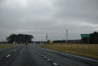 Johnson Road (Rd 207) ties into the west side of SR 1 as the old route of SR 30A west 0.74 miles to SR 30.