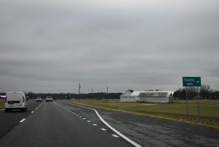 Slaughter Neck Road (Rd 215) runs 3.35 miles west across Slaughter Neck from SR 1 to SR 30 (Cedar Creek Road).
