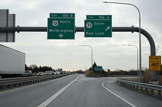 Exit 156 A partitions with Exit 156 B for SR 71 (Red Lion Road) south. SR 71 comprises a 21.99 mile long loop west from U.S. 13 (Dupont Highway) through Red Lion, Summit Bridge and Middletown and U.S. 13 south of Townsend.