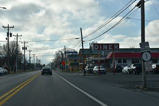Walnut Street initially runs south between the commercial corridor along adjacent U.S. 113 (Dupont Boulevard) and Milford Central Academy / Milford High School.