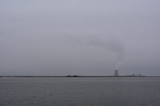 SR 9 (St. Augustine Road) runs directly alongside the Delaware River at Augustine Beach. Visible to the southeast is Hope Creek Generating Station in Salem County, New Jersey.