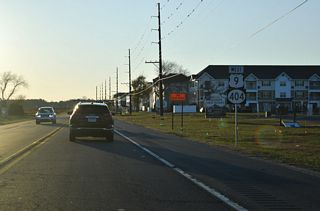 U.S. 9/SR 404 shields posted west of Nassau Commons Boulevard. Work preceding the expansion of U.S. 9 to a four lane boulevard between SR 1 and Old Vine Boulevard included adding traffic lights at Nassau Commons Boulevard (Roth, 2025a). Those signals were activated on November 21, 2025 (Roth, 2025b).
