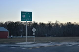 Prior to 2024, U.S. 9 Truck turned south on S Bedford Street to U.S. 113. The realignment overtook Arrow Safety Road 0.47 miles west to U.S. 113.