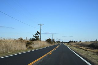 SR 16 turns southeast from Broadkill Neck across wetland areas in Prime Hook National Wildlife Refuge.