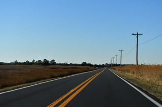 SR 16 (Broadkill Road) turns northwest from Petersfield Island across wetlands in Prime Hook National Wildlife Refuge before resuming southwest along Broadkill Neck.