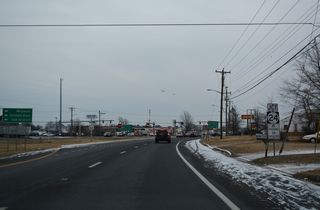 U.S. 113/SR 20-24 (Dupont Boulevard) advance southeast through a commercial strip to Laurel Road and SR 24 Business (Washington Street) southwest of Downtown Millsboro.
