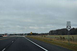 SR 24 (John J. Williams Highway) shifts north ahead of SR 24 Business and the North Millsboro Bypass. SR 24 Business follows the previous alignment of SR 24 leading southwest to Downtown Millsboro.