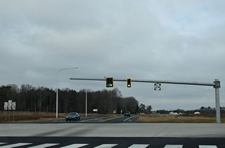Hollyville Road south previously intersected SR 24 (John J. Williams Highway) cross from Jersey Road to the south. The road was realigned to a new signalized intersection with the North Millsboro Bypass in 2025.
