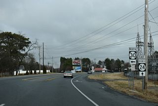 SR 24 Business curves east from SR 30 (Gravel Hill Road) along John J. Williams Highway to Angola and Midway.